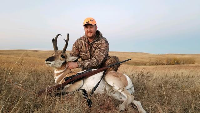 Dave with a pronghorn antelope on the prairie